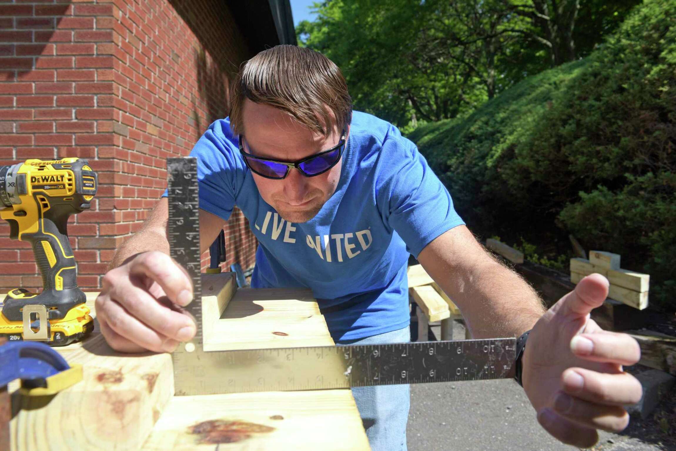A volunteer from Belimo helps to build a wheelchair accessible picnic table during the United Way of Western Connecticut's Day of Action