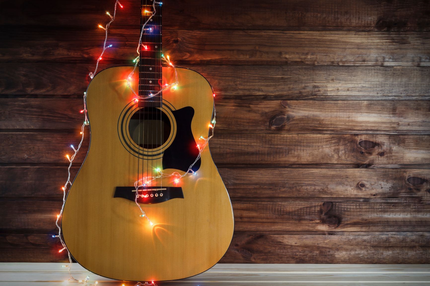 Acoustic Guitar decorated with holiday lights