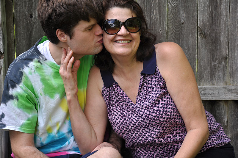 Son kissing happy mom|||