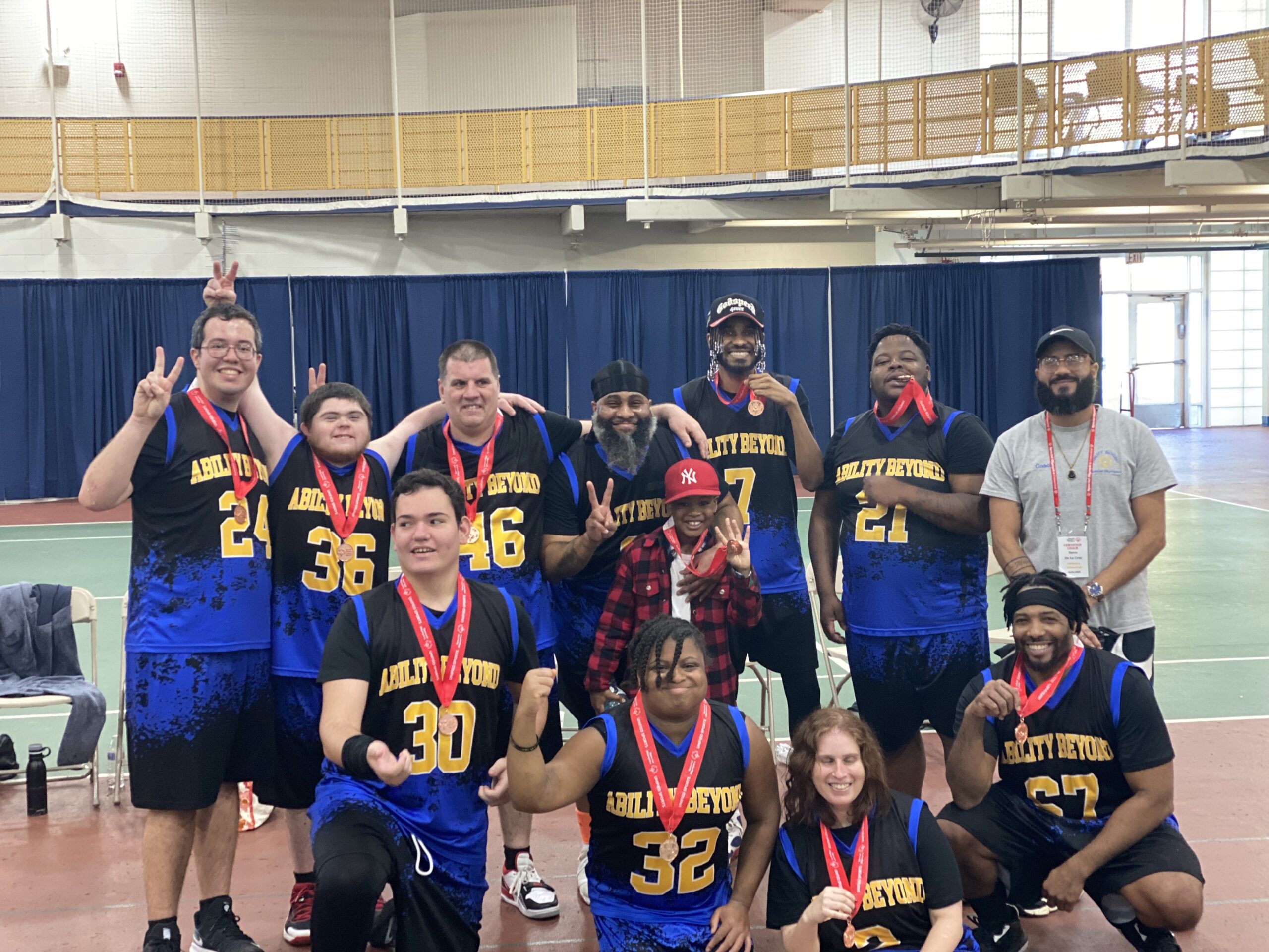 a photo of Jason (back row, third from left) with his unified basketball team