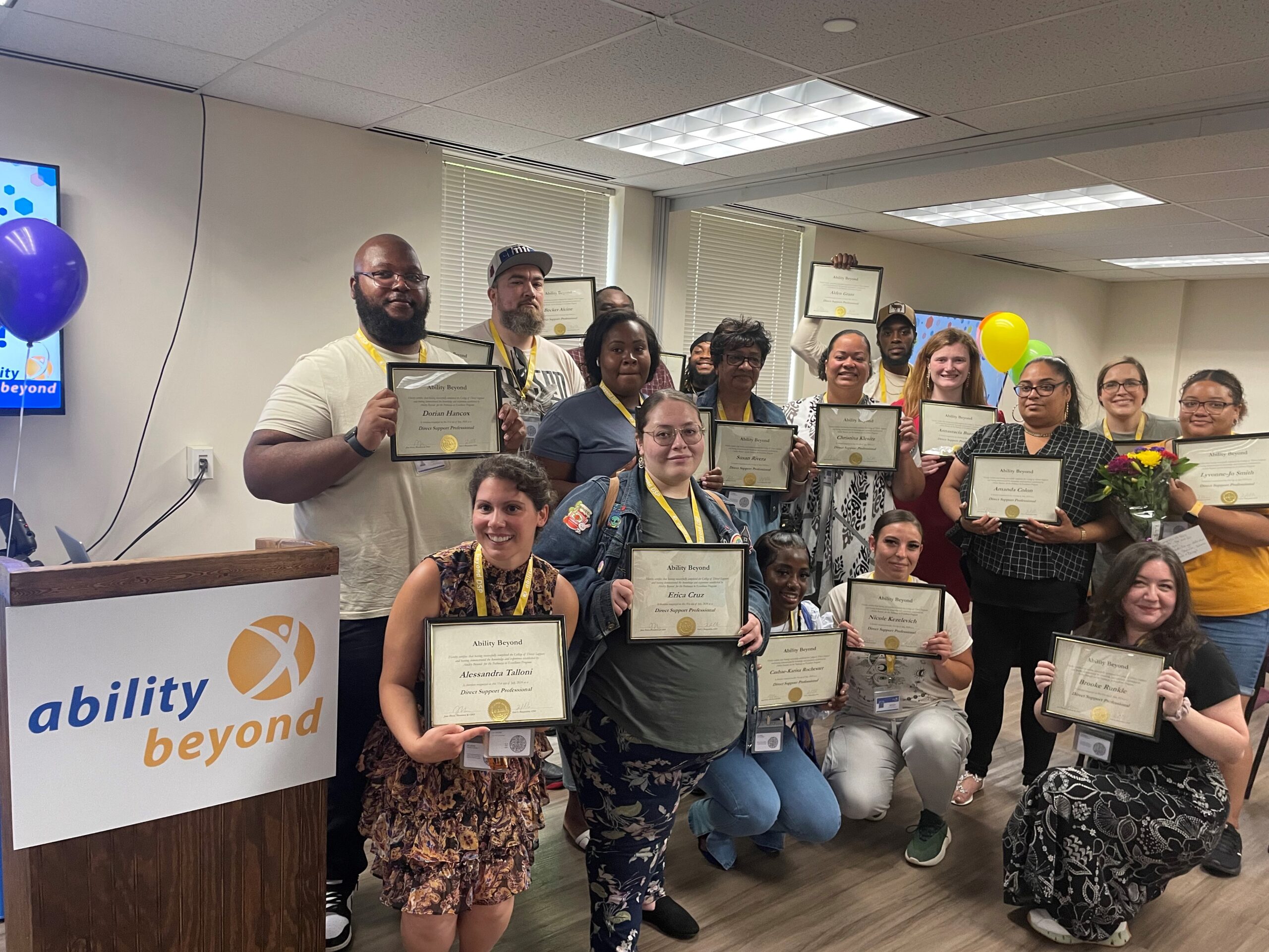 Direct Support Professionals graduting from our Pathways program pose with their certificates.