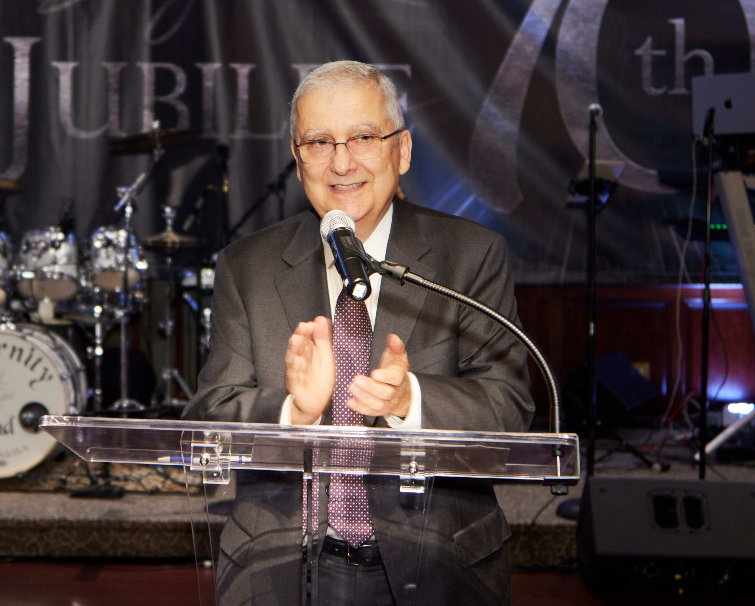 Bob Bedoukian stands before a microphone during an Ability Beyond Gala