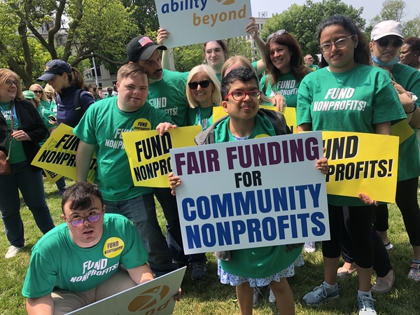 A photograph showing attendess at last year's rally holding up signs calling for fair funding